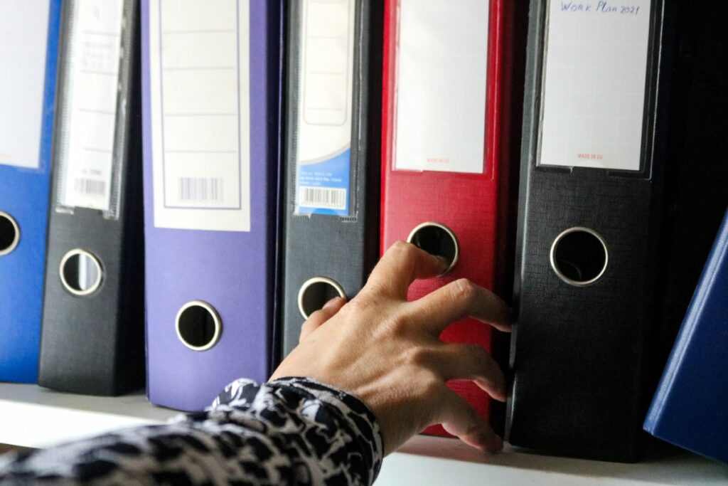 Une personne prenant un classeur avec un registre d'une entreprise