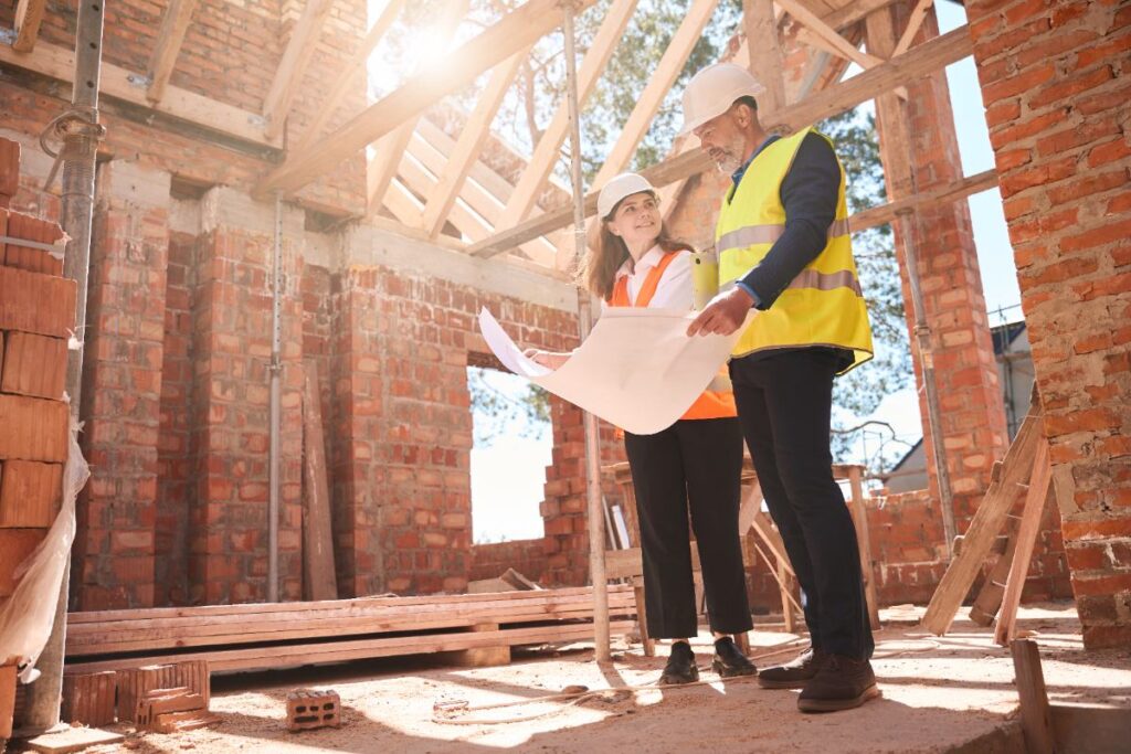 Des ingénieurs de bâtiment professionnels qui discutent dans un chantier