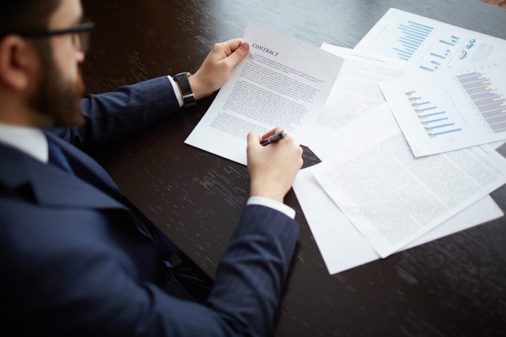 Un homme signant un contrat dans son bureau